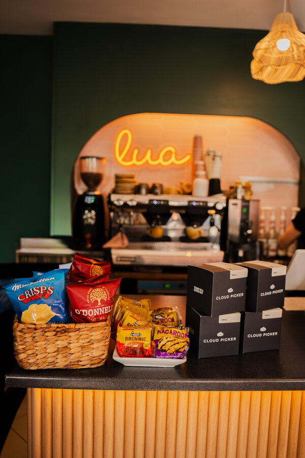 Lua Cafe counter with its illuminated sign and locally stocked snacks in the foreground